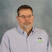 Headshot of Casey Littlefield with blue background
