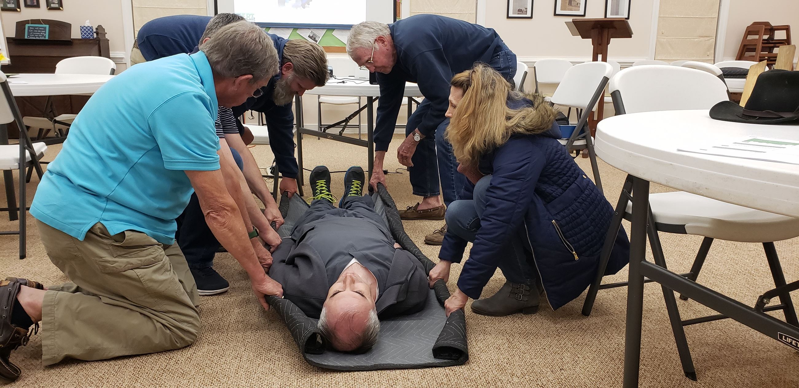 Goochland 2022 CERT Class - Practicing getting a blacket under a patient